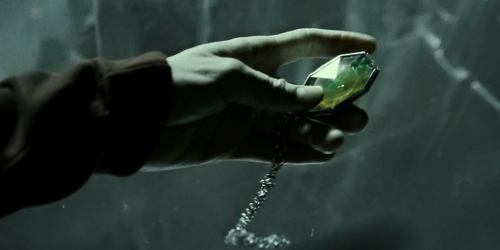 Harry holds the Slytherin Locket Horcrux in Harry Potter.