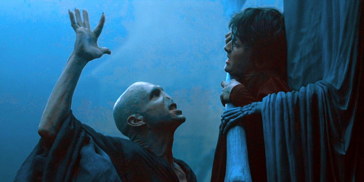 Voldemort stands in front of a trapped Harry Potter with his hand raised in Goblet of Fire.