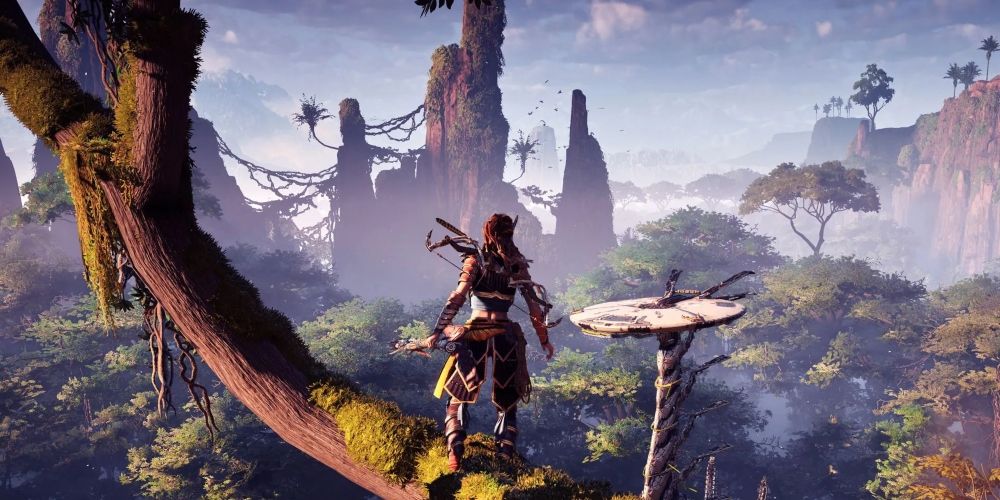 Aloy looking out over the open world and a tallneck in Horizon Zero Dawn 