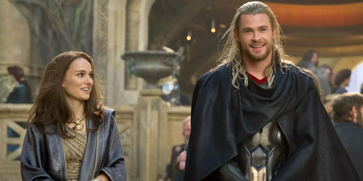 Jane Foster and Thor Odinson smiling while Jane looks at him in Thor: The Dark World.