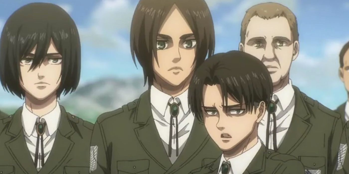 Levi standing in front of Eren and Mikasa in Attack On Titan.