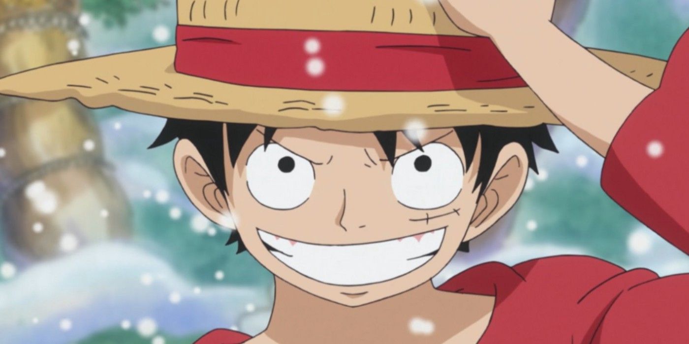 Luffy from One Piece smirking and holding his straw hat.
