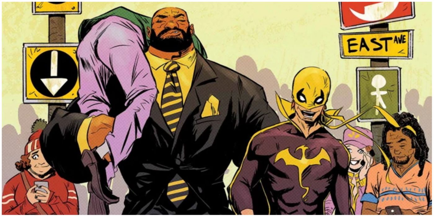 Luke cage with someone over his shoulder walking next to iron fist in Marvel comics