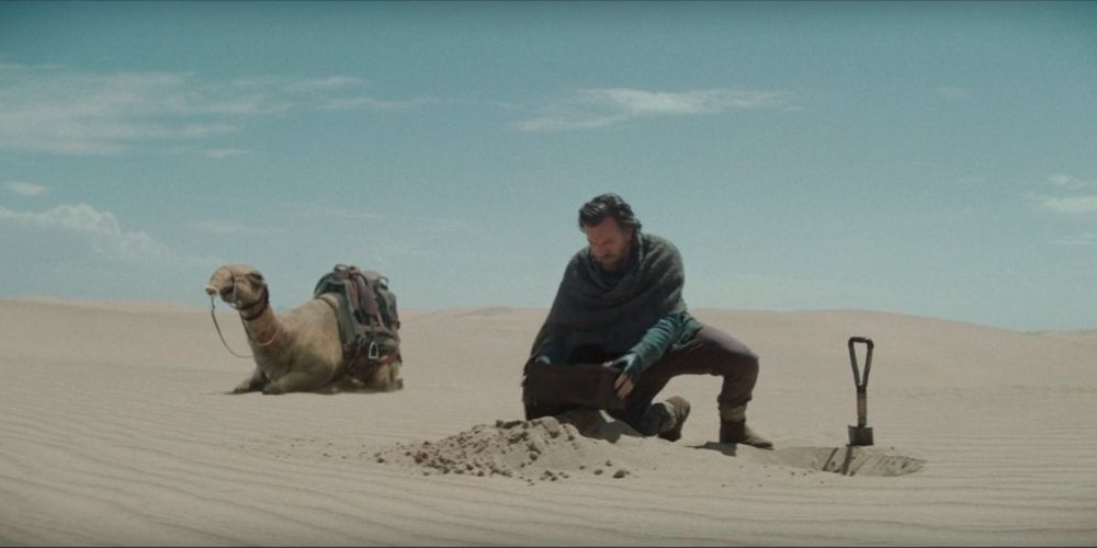 Obi-Wan digging up his and Anakin's buried lightsabers in Obi-Wan Kenobi show