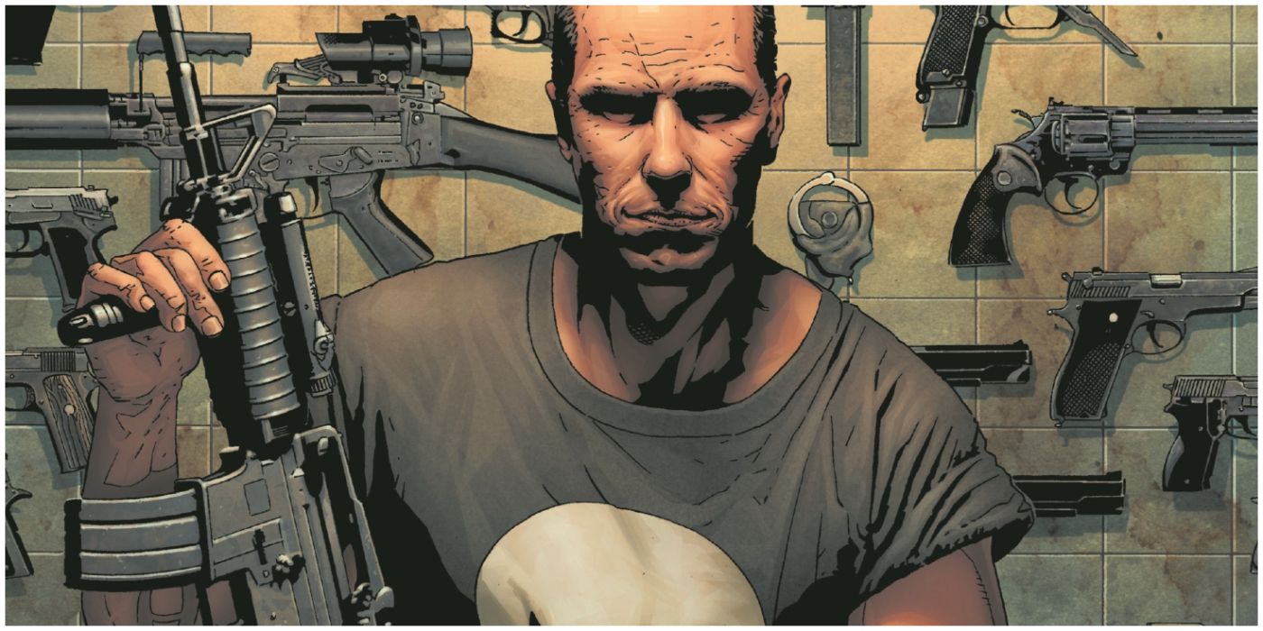 Punisher holds an assault rifle and stands in front of his weapons rack.