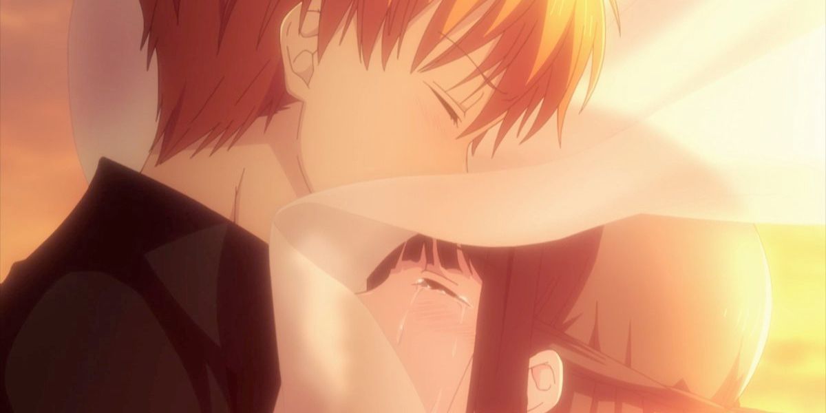 Kyo is comforting a crying Tohru (Fruits Basket)