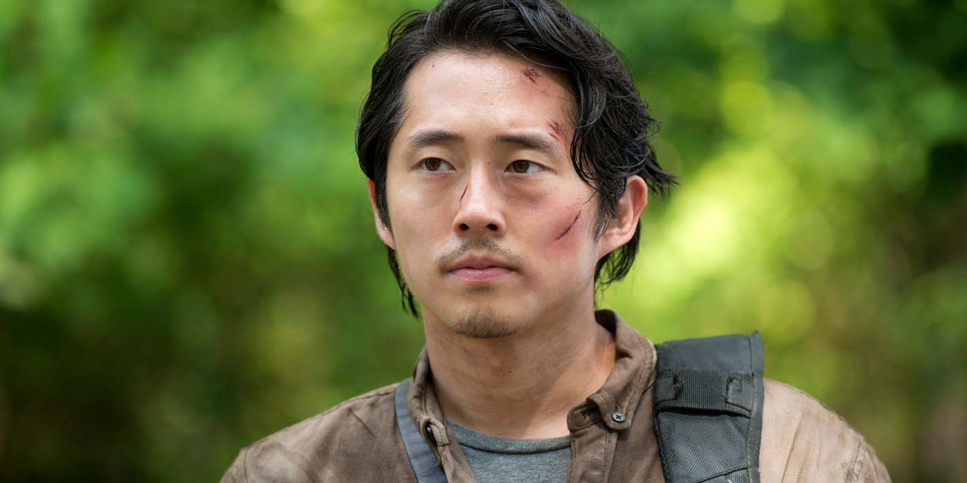 Steven Yeun as Glenn in The Walking Dead standing with some scars on his face.