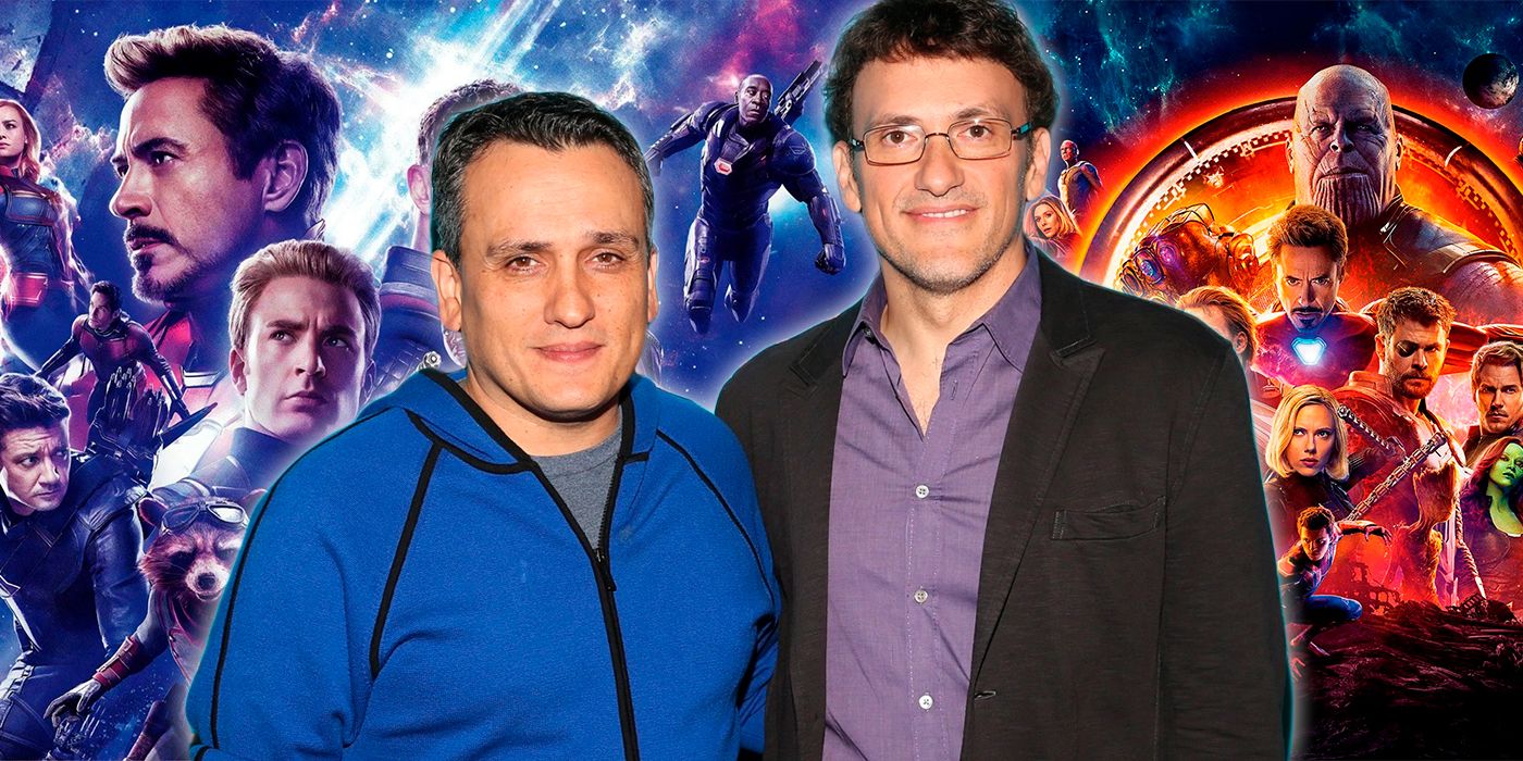 Joe and Anthony Russo stand in front of an image of the Marvel Cinematic Universe heroes.