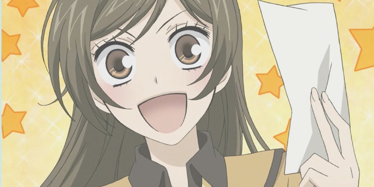 Nanami excited holding a paper talisman in Kamisama Kiss.