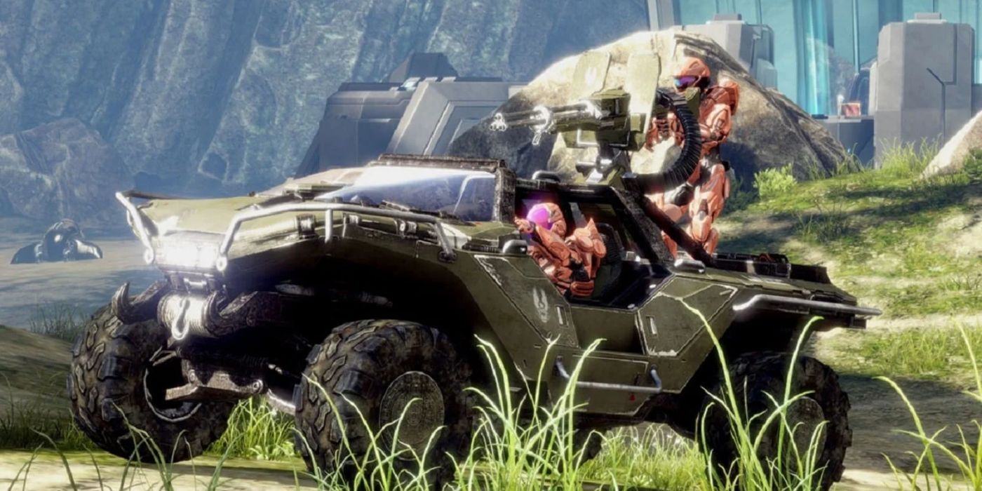 The warthog from Halo Infinite with a couple Spartans in it on a grassy hill.