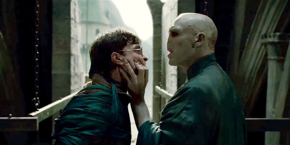 Lord Voldemort holding Harry Potter's face