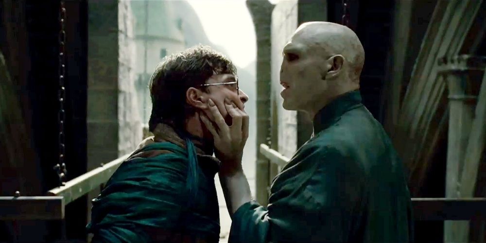 Lord Voldemort clutching Harry Potter's face.