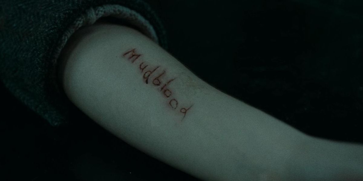 Bellatrix tortures Hermione with "mudblood" on her arm