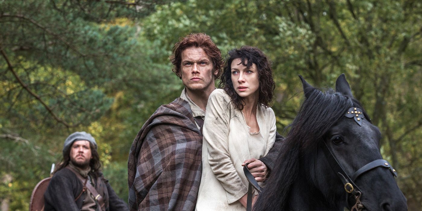 Jamie and Claire ride a horse in Outlander.