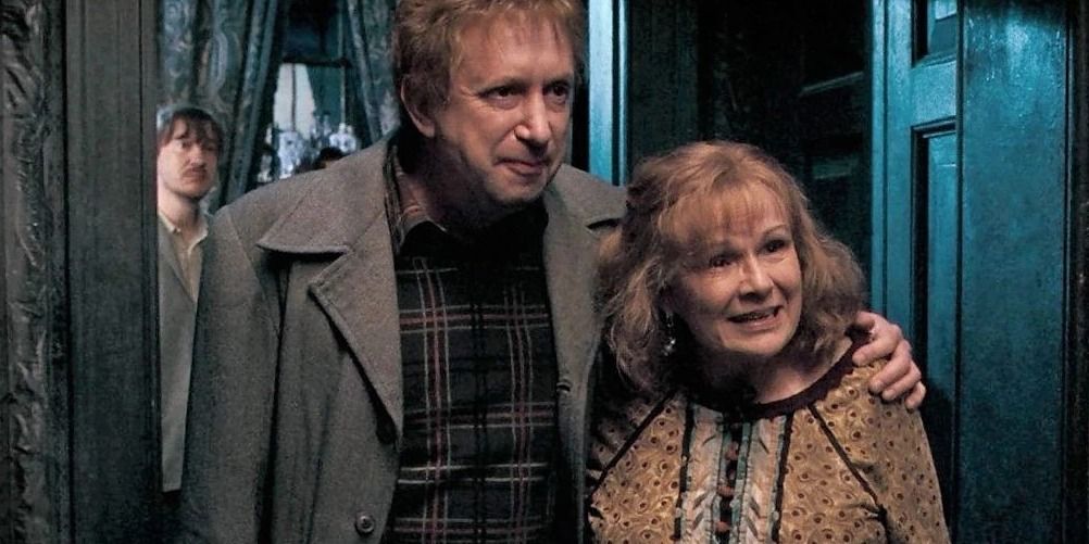 Arthur and Molly Weasley stand together smiling at 12 Grimmauld Place