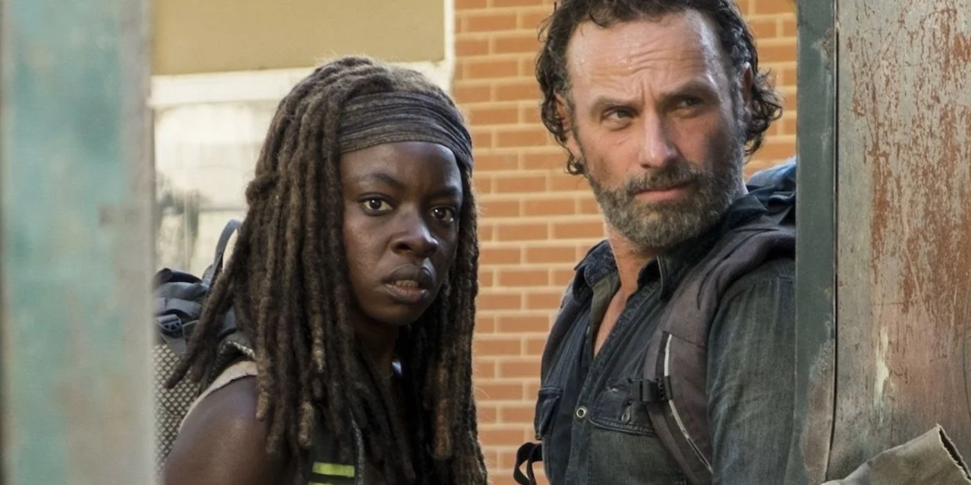 Rick (Andrew Lincoln) and Michonne (Danai Gurira) look through an opening in the Walking Dead