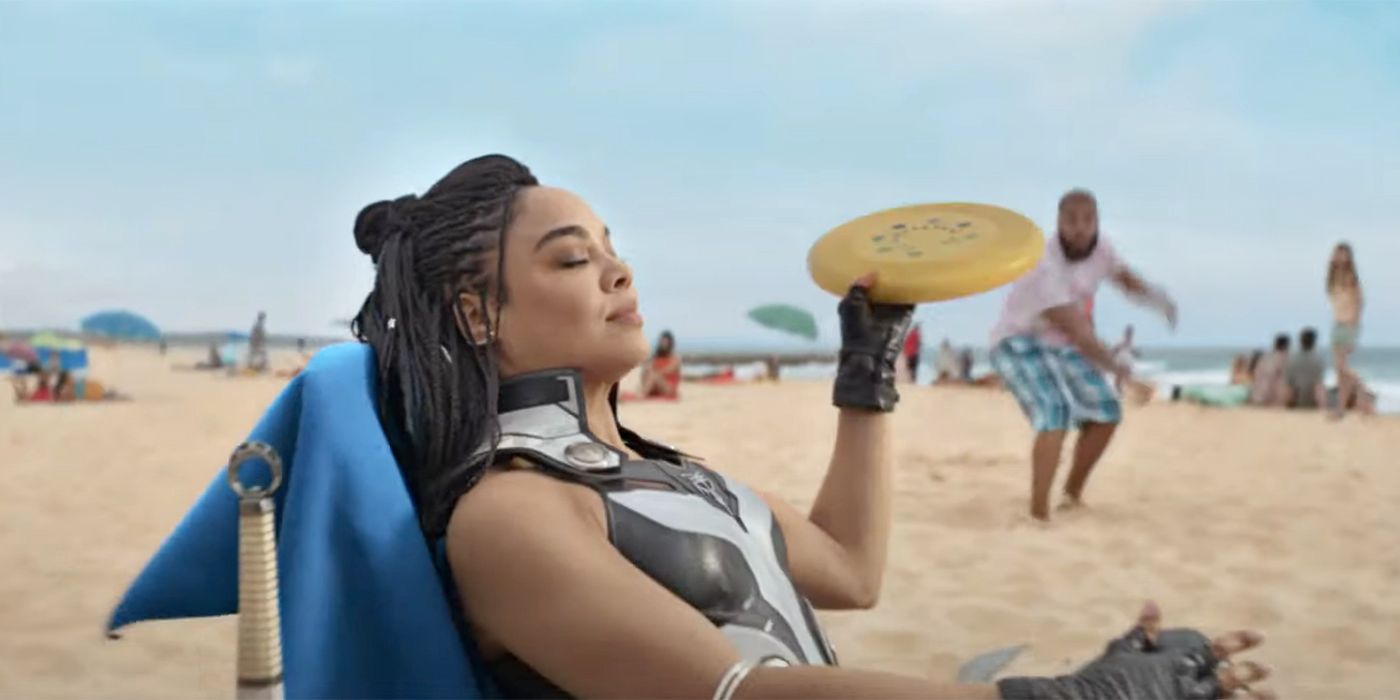 Valkyrie from Thor Love and Thunder catching a frisbee on the beach with eyes closed