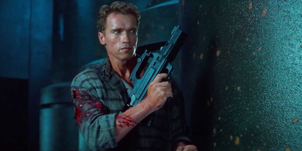 Arnold Schwarzenegger holding a gun in Total Recall