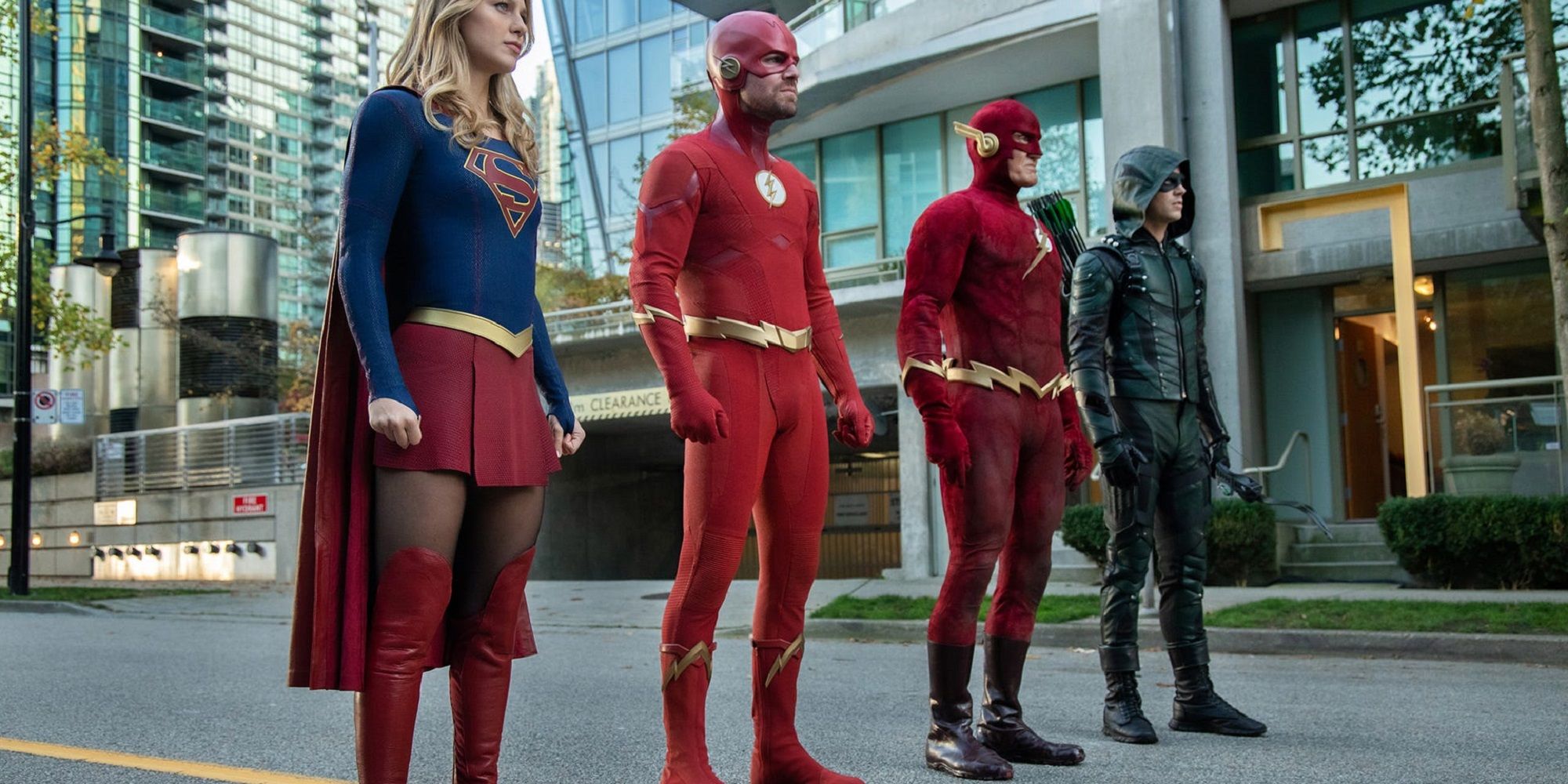 Supergirl, Green Arrow, both versions of The Flash align ready to face battle.