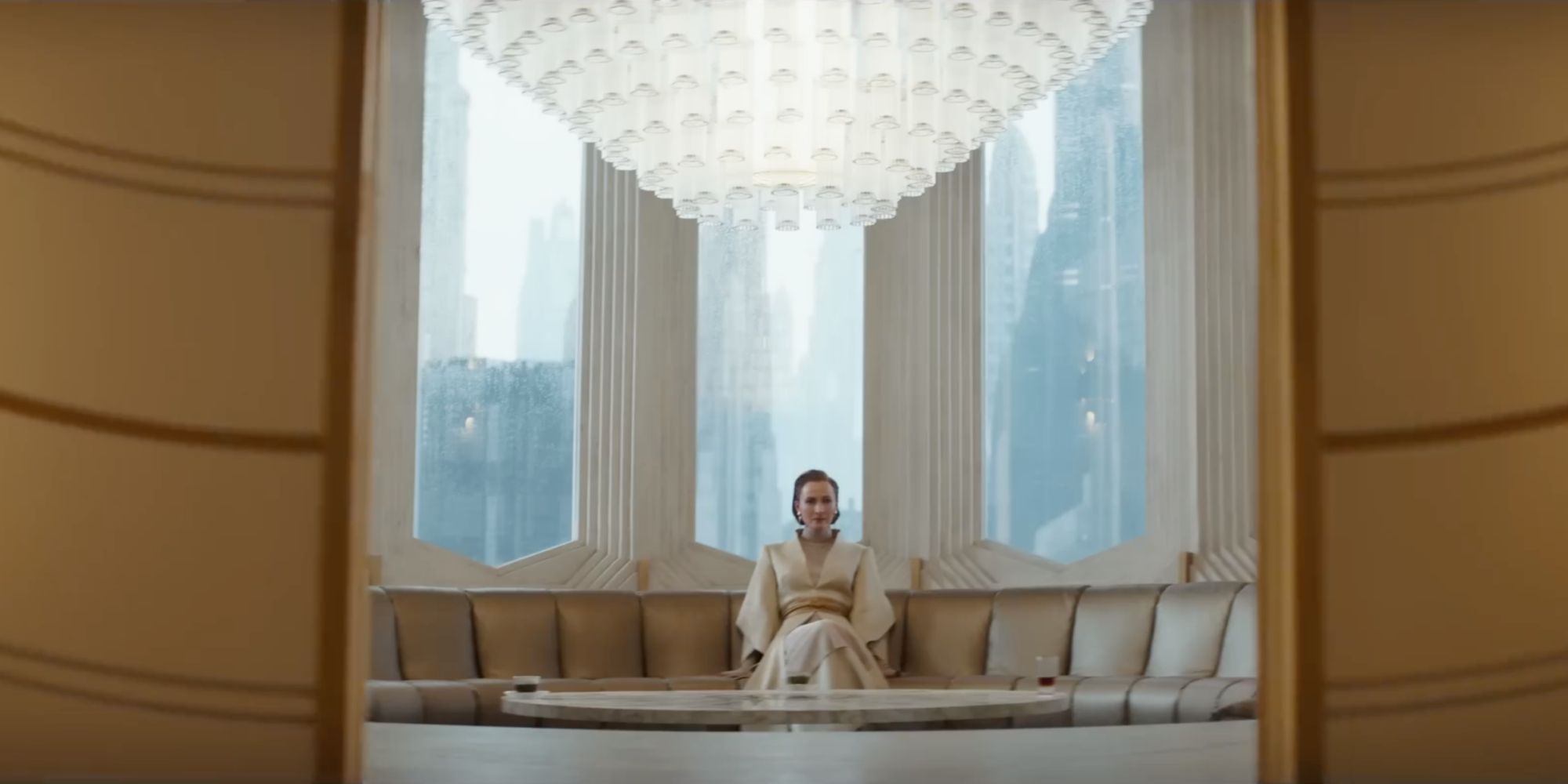 Mon Mothma sits alone beneath a chandelier as the doors close on her in Andor.