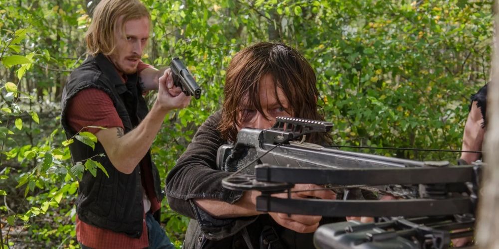 Dwight points his gun at Daryl in The Walking Dead