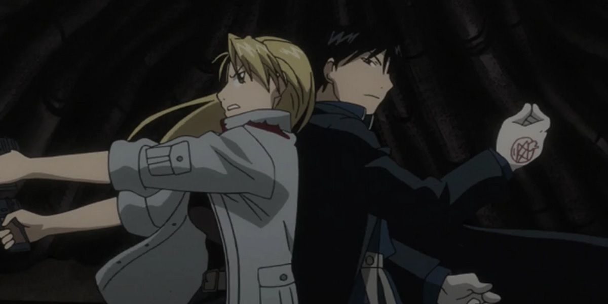 Riza and Roy back-to-back during a fight in Fullmetal Alchemist: Brotherhood.