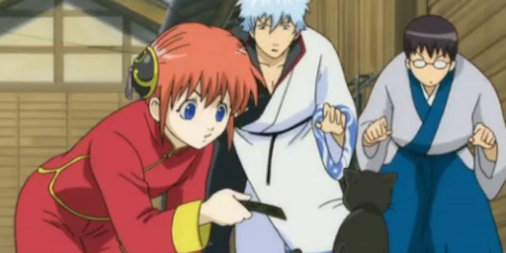 Kagura lures cat with food in Gintama Episode 1.
