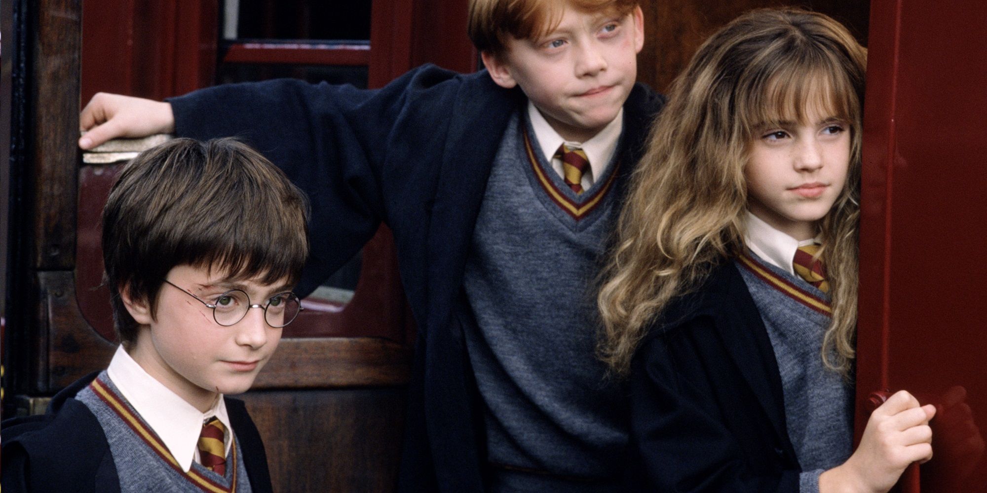 Harry, Ron and Hermione boarding the Hogwarts Express