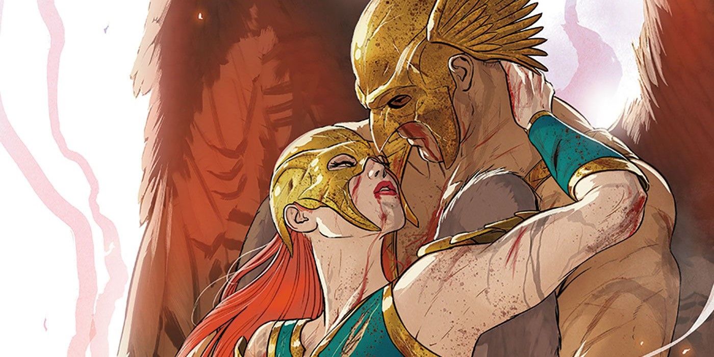 Hawkman and Hawkwoman, bloodied after battle, lean in for a kiss in DC Comics
