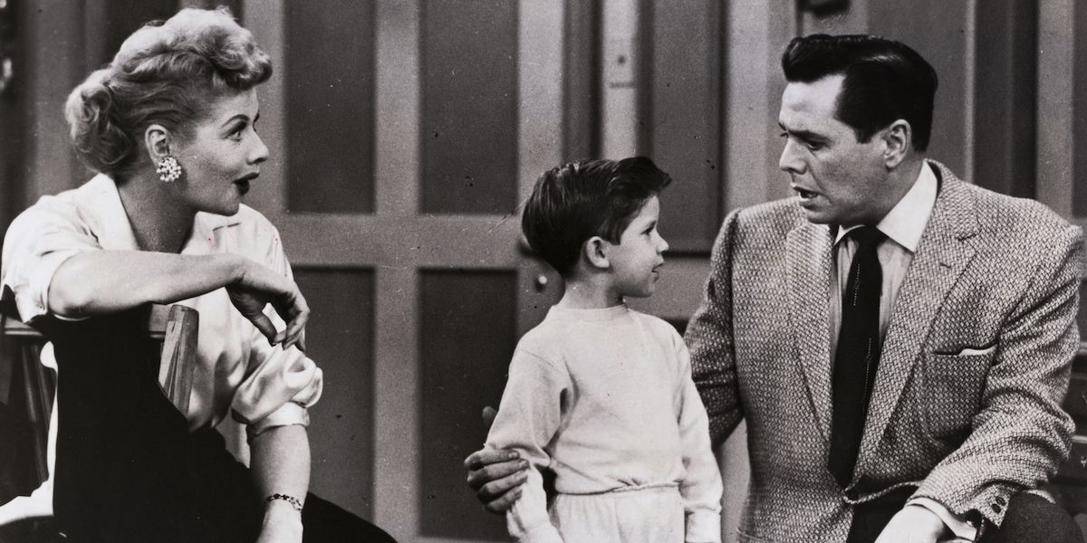 Lucy watches her husband talk to their son in I Love Lucy.