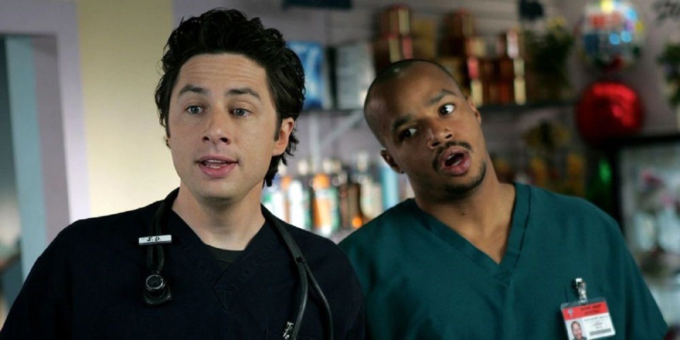 JD and Turk stand beside one another in Scrubs