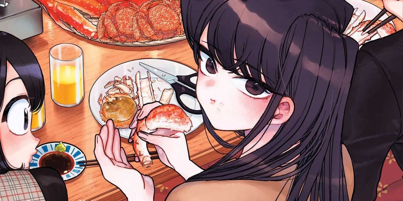 Komi eating a crab leg while seated in a restaurant with friends in Komi Can't Communicate manga.