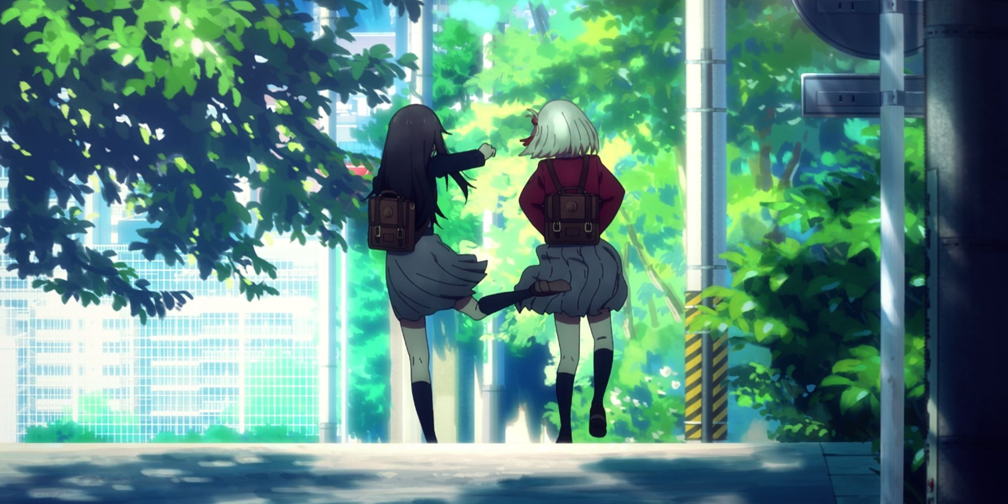 Takina kicks Chisato from behind in Lycoris Recoil's opening credits sequence.