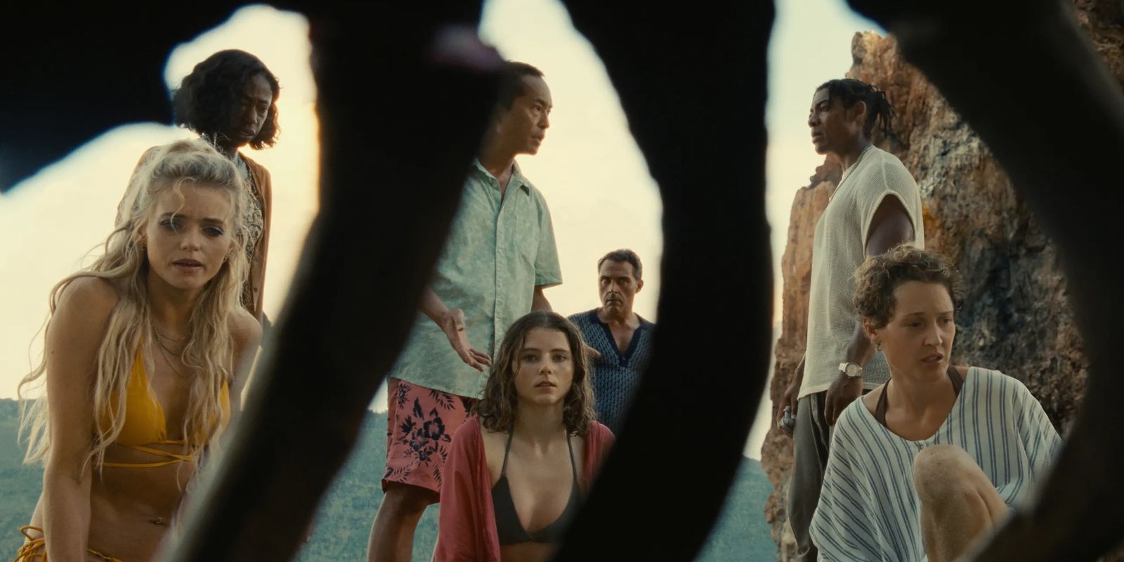 The cast is seen through a set of ribs on a corpse in M. Night Shyamalan's Old.