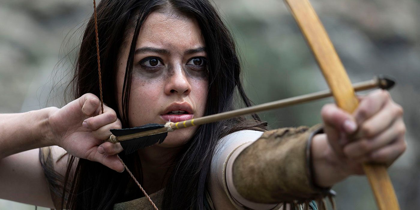 An image from the movie Prey shows Naru preparing to shoot an arrow from her bow.