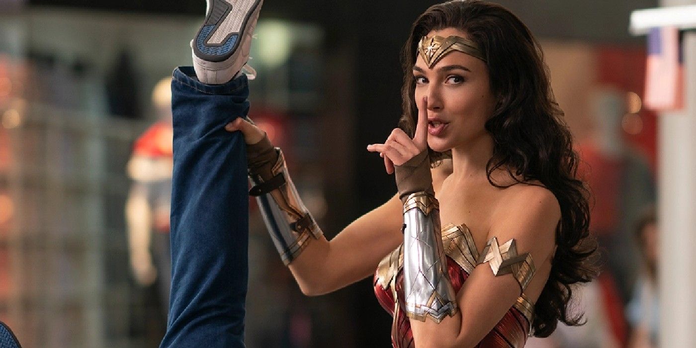 Princess Diana dangling a criminal from one leg and shushing the camera in Wonder Woman 1984.