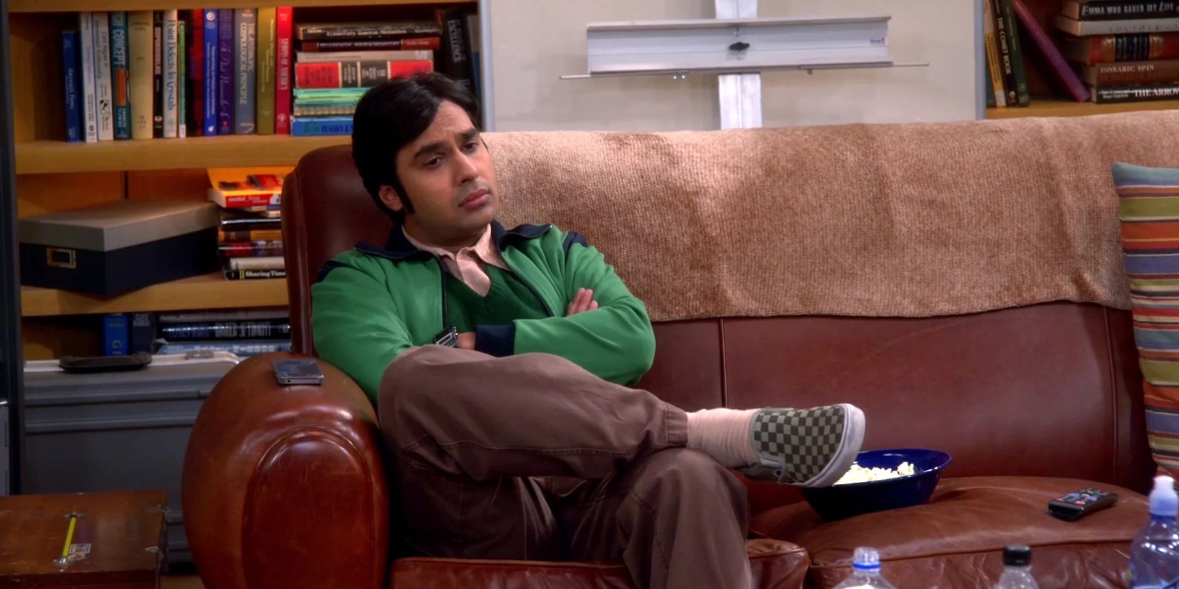 Rajesh Koothrappali sitting on a couch in Big Bang Theory
