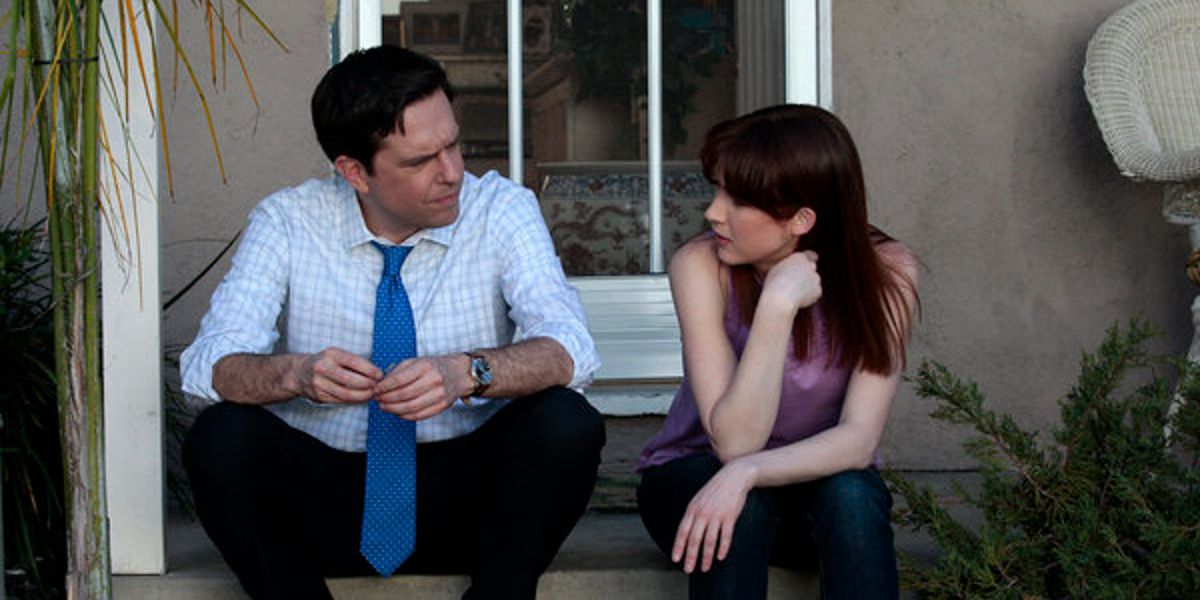 Andy and Erin sitting on steps in The Office