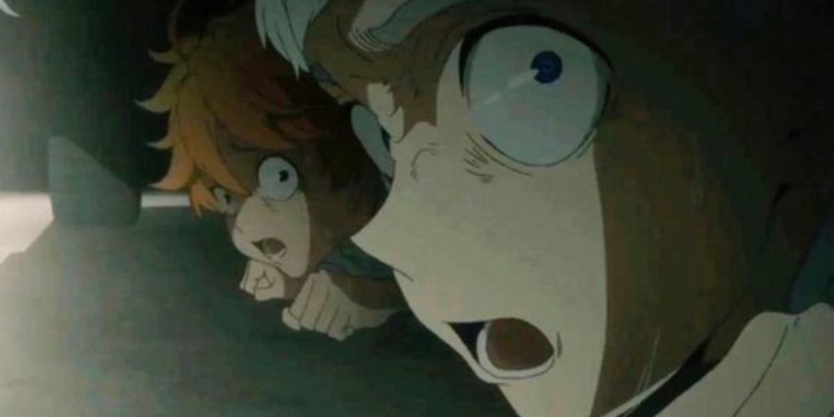 Emma and Norman hiding under the bed in The Promised Neverland.