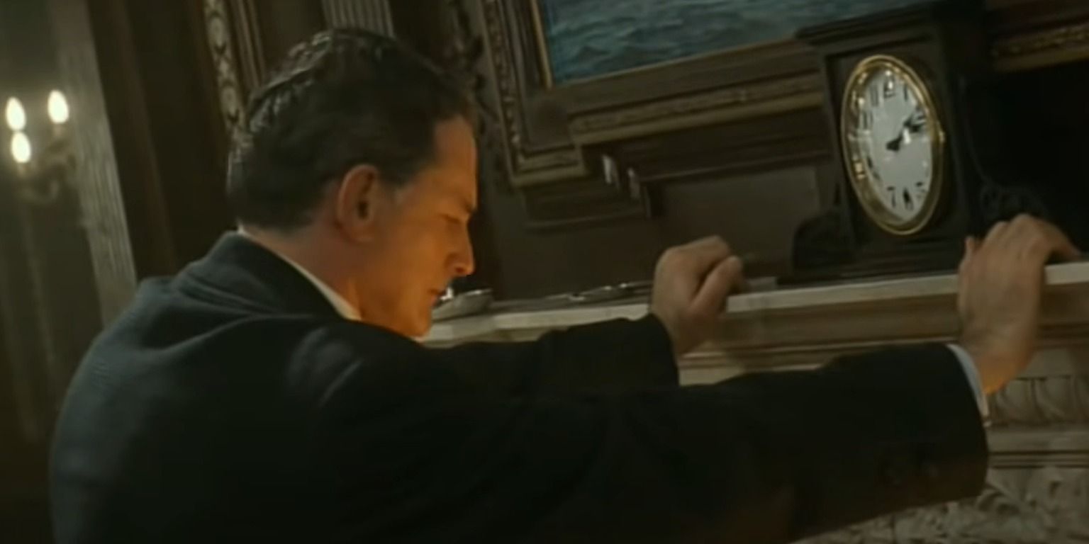 Thomas Andrews leans against the mantel with clock - Titanic (1997)