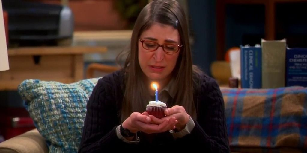 The Big Bang Theory's Amy Farrah Fowler sadly holds a cupcake.