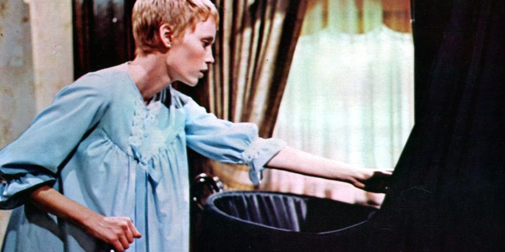 Mia farrow with baby carriage and a knife in rosemary's baby