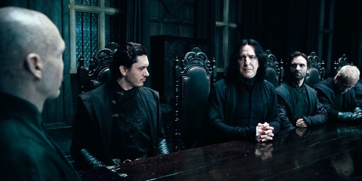 Snape at a table with Voldemort and other Death Eaters.
