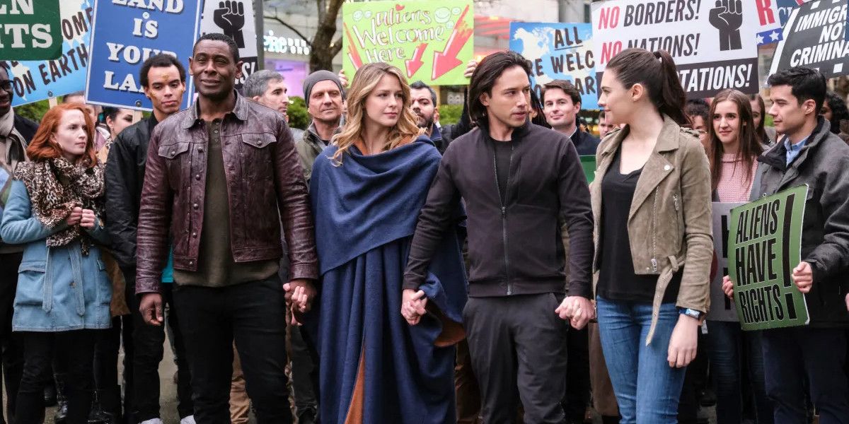 supergirl in the middle of a protest