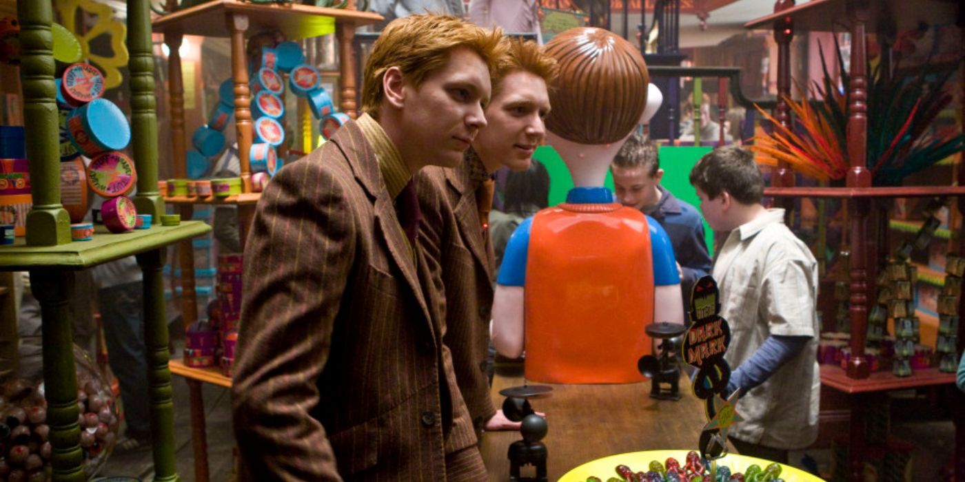 Fred and George walk through their store, which is filled with bright, quirky products