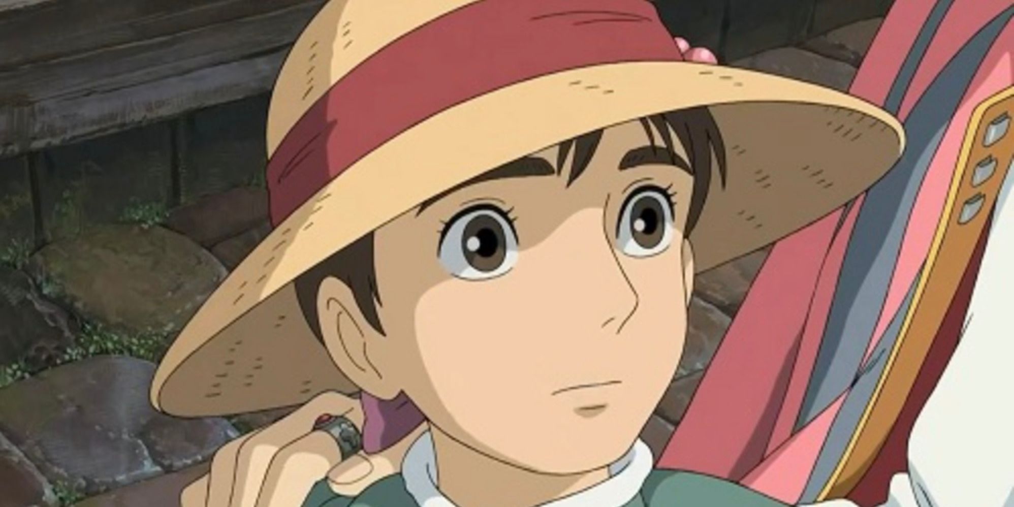 Young Sophie wearing hat and looking up nervously at Howl in Howl's Moving Castle