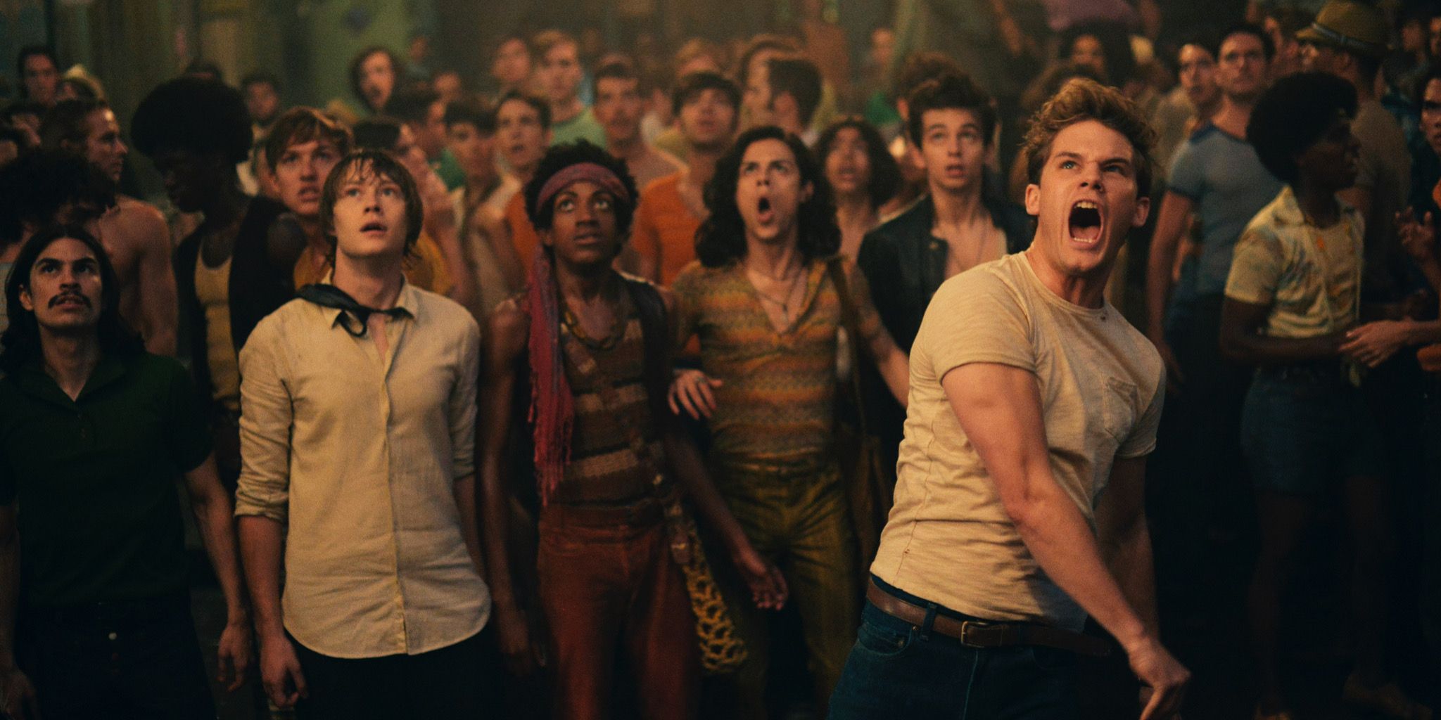Male throwing something amid crowd in movie Stonewall