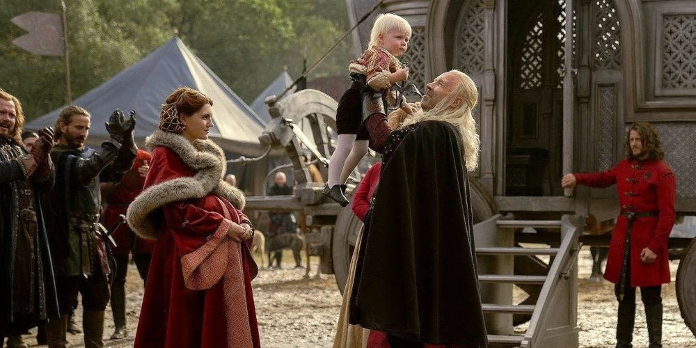Alicent Hightower and King Viserys I Targaryen with the infant Aegon Targaryen in House of the Dragon