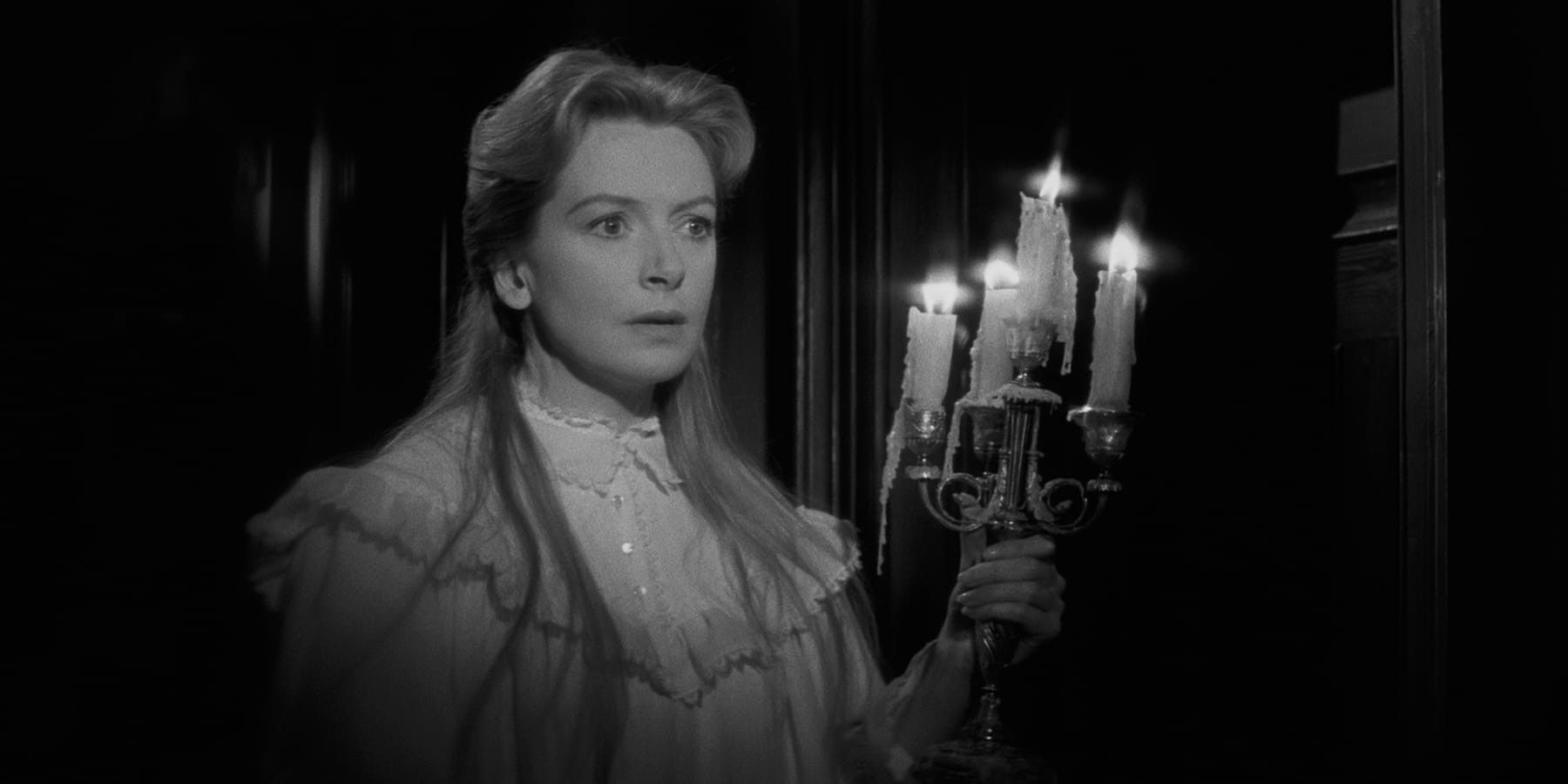 miss giddens holds a candelabra in the innocents 1961
