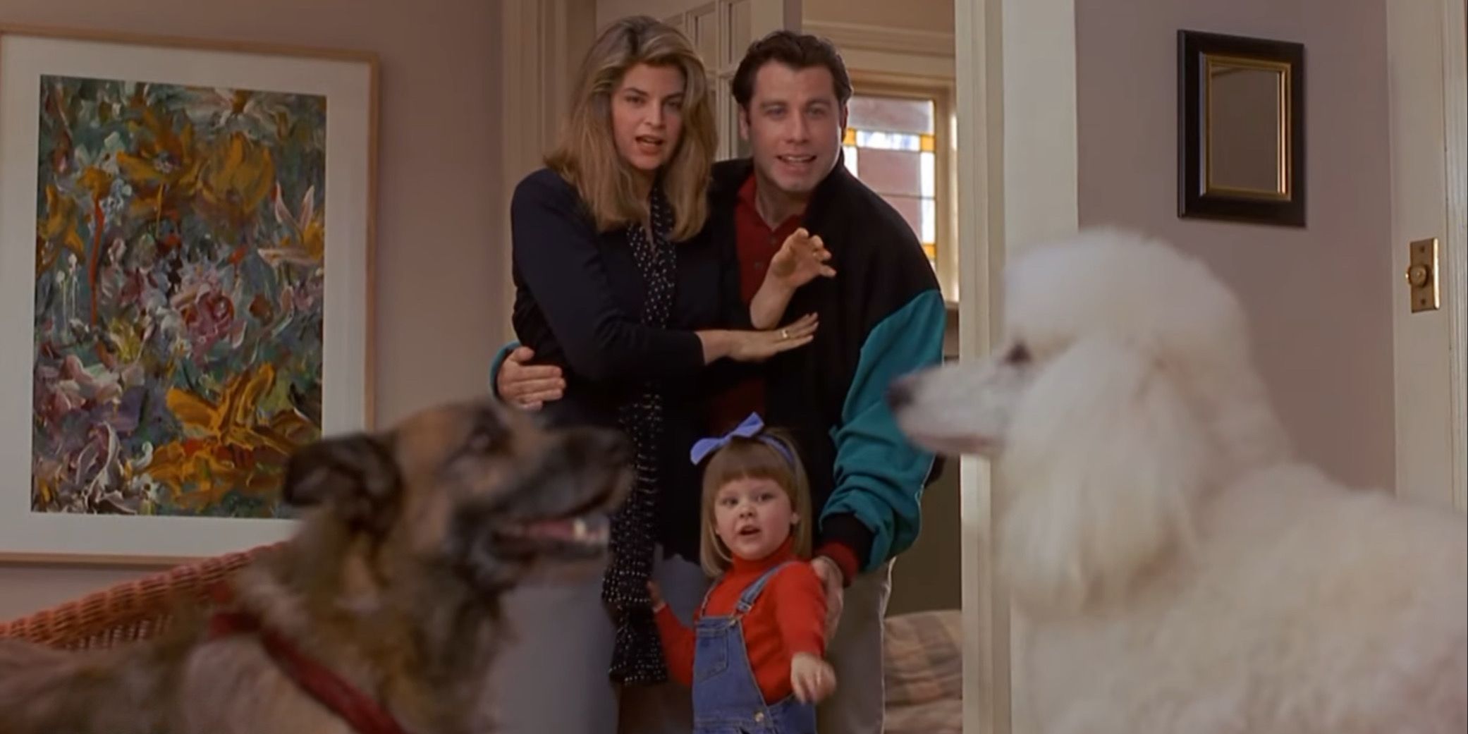 Two dogs, a small child, Kim Cattrall and John Travolta in Look Who's Talking Now